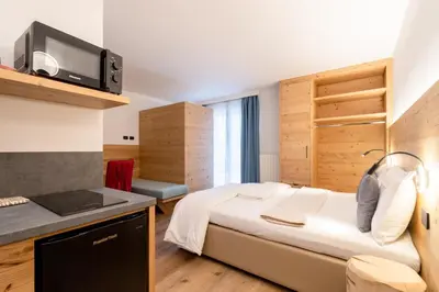 a kitchen with a sink and a stove at Negritella Sweet Hotel in Ziano di Fiemme