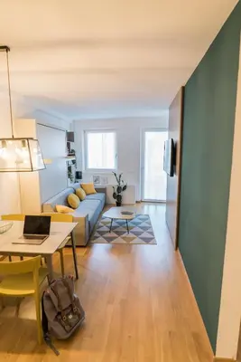 a living room with a couch and a table at Stay COOPER l MAVIK Loft & Apartment in Bolzano