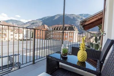 a balcony with a table with a pineapple on it at Stay COOPER l MAVIK Loft & Apartment in Bolzano