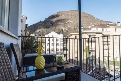 a pineapple sitting on a table on a balcony at Stay COOPER l MAVIK Loft & Apartment in Bolzano