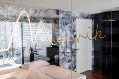a bedroom with a sign that reads hotel in a window at Stay COOPER l MAVIK Loft & Apartment in Bolzano