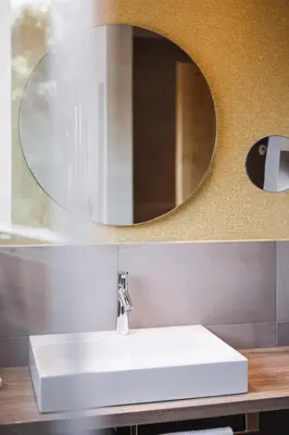 a bathroom with a white sink and a mirror at Hotel Garni Andrianerhof in Andrian