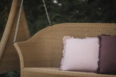 a pillow sitting on a swinging chair with a purple pillow at Hotel Garni Andrianerhof in Andrian
