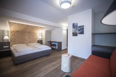a hotel room with a bed and a desk at Hotel Garni Andrianerhof in Andrian
