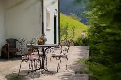 a table and chairs sitting on a patio at La Piccola Casa Verde in Canale San Bovo