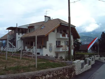 a white house with a brown roof at Residence Nesslerheim in Termeno