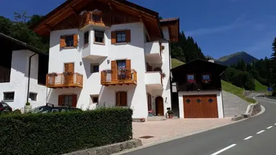 a white building with balconies on the side of a road at HartlHof in Proves