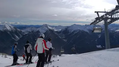 a group of people on a ski lift on a mountain at HartlHof in Proves