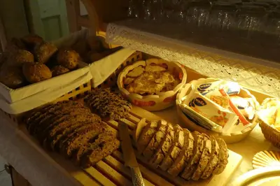 a table with different types of food on it at Hotel Garni Concordia - Dolomites Home in Selva di Val Gardena