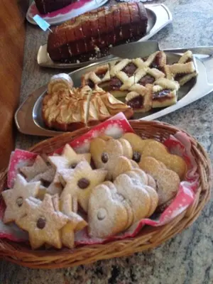 a basket filled with cookies and other pastries on a table at Garni Enrosadira in Vigo di Fassa