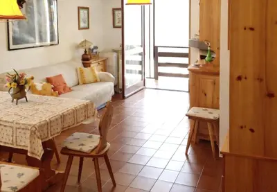 a living room with a table and a couch at Casa Tiziana By Go New Location in Carano
