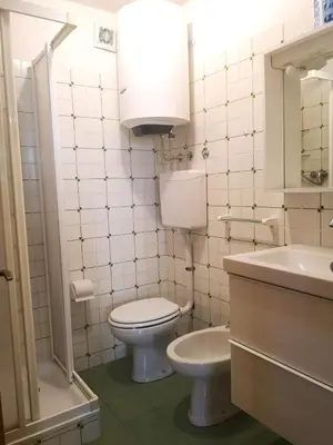 a white bathroom with a toilet and a sink at Casa Tiziana By Go New Location in Carano