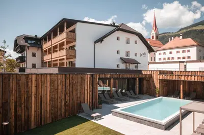 a swimming pool on the roof of a building at Hotel Gasthof Jochele in Falzes