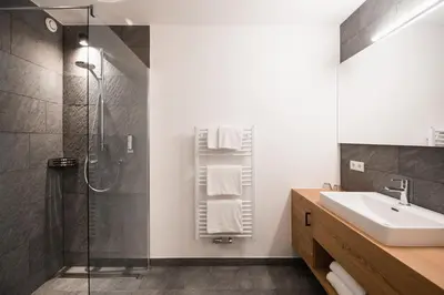 a bathroom with a shower and a sink at Hotel Gasthof Jochele in Falzes