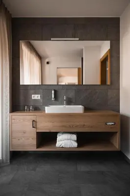 a bathroom with a sink and a mirror at Hotel Gasthof Jochele in Falzes