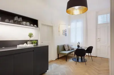 a kitchen and dining room with a table and chairs at Arcade Apartments in Bolzano