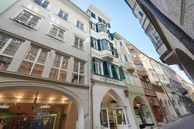a group of buildings on a city street at Arcade Apartments in Bolzano