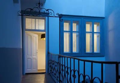 a blue room with a door and a window at Arcade Apartments in Bolzano