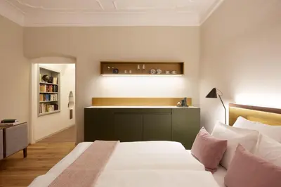 a bedroom with a bed and a sink in it at Arcade Apartments in Bolzano