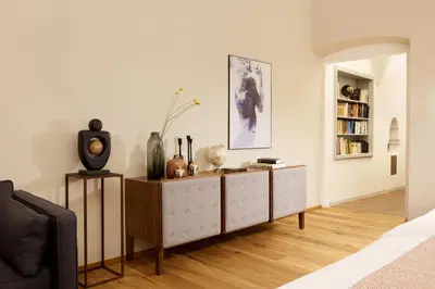 a living room with a cabinet and a book shelf at Arcade Apartments in Bolzano