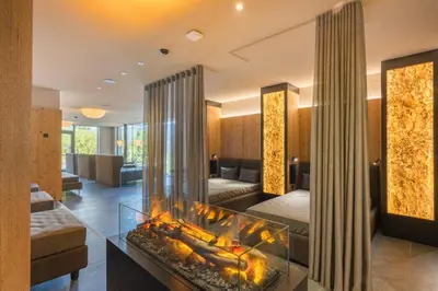 a living room with a large aquarium in the middle at Hotel Christoph in Valdaora