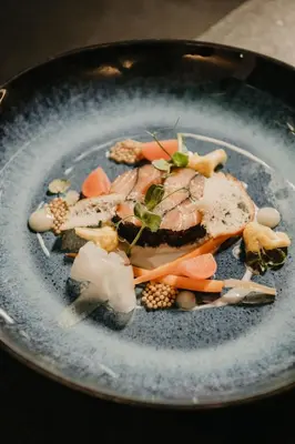 a plate of food with meat and vegetables on it at Hotel Christoph in Valdaora