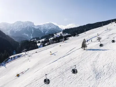 a group of people skiing down a snow covered slope at Hotel Christoph in Valdaora