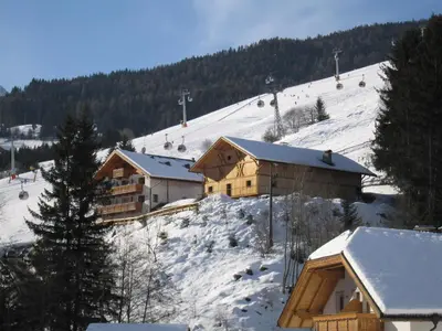 a ski lodge in the snow with a ski lift at Residence Mühlegg in Valdaora