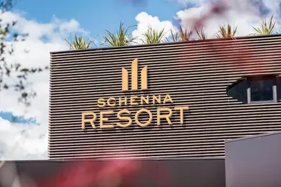 a sign for a resort on the side of a building at Hotel Rosengarten (Schenna Resort) in Schenna