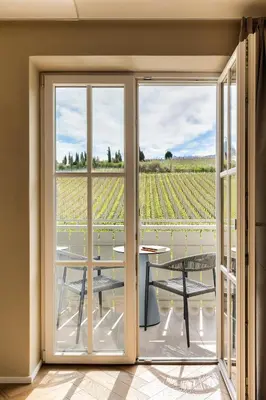 a room with doors and a view of a vineyard at Lingers Suites & Residence in Appiano sulla Strada del Vino