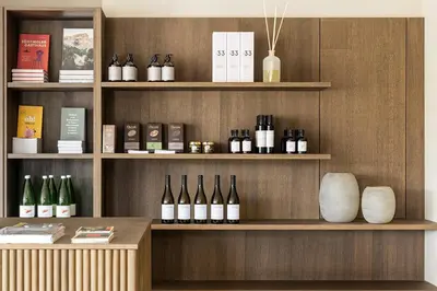 a shelf with bottles of wine on it at Lingers Suites & Residence in Appiano sulla Strada del Vino