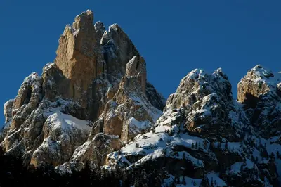 a rocky mountain with snow on it at Appartamenti Casari in Pozza di Fassa