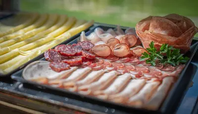 a tray of meats and cheese on a display at Garni Sunela B&B in Selva di Val Gardena
