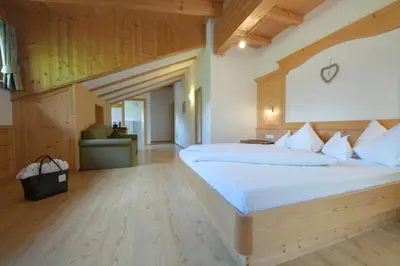 a bedroom with a large bed in a room at Garni Sunela B&B in Selva di Val Gardena