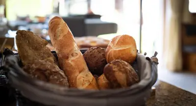 a basket filled with bread and pastries on a counter at Garni Sunela B&B in Selva di Val Gardena