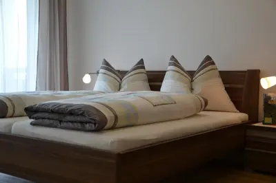 a bed with pillows on top of it at Oberberghof in Appiano sulla Strada del Vino