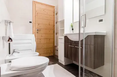 a bathroom with a toilet and a sink at Apartment Rainer in Ortisei
