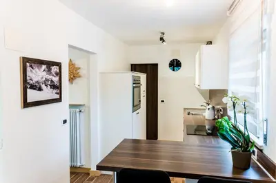 a kitchen and dining room with a wooden table at Apartment Rainer in Ortisei