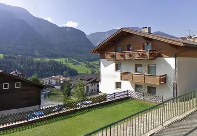 a house on a hill with a balcony at Apartment Rainer in Ortisei