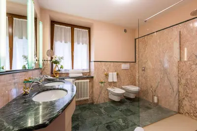 a bathroom with a sink and a toilet and a shower at Relais Villa Quercia in Tassullo