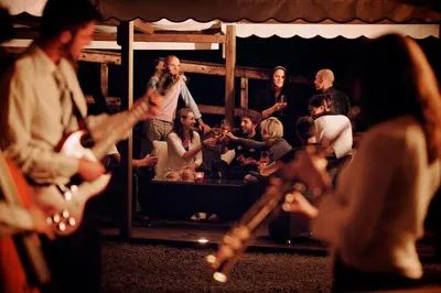 a group of people singing and playing music at Hotel Castel Pietra in Fiera di Primiero