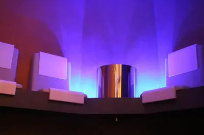 a stage with purple lights and a metal cylinder at Hotel Castel Pietra in Fiera di Primiero