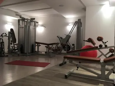 a gym with treadmills and exercise machines at Hotel Castel Pietra in Fiera di Primiero