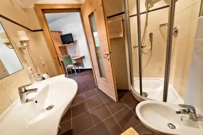 a bathroom with a sink and a shower at Garni Pramstrahler in Chiusa