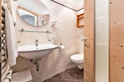a bathroom with a sink and a toilet at Garni Pramstrahler in Chiusa