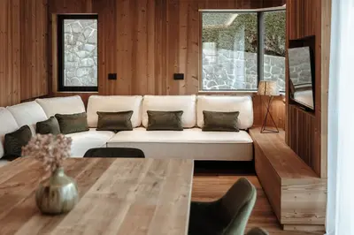 a living room with a white couch and a table at Appartamenti Insam in Santa Cristina in Val Gardena