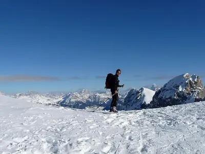 a man standing on top of a snow covered mountain at Appartamento San Marco in Caprile