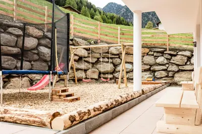 a play area with a rock wall at Hotel Almina in Racines
