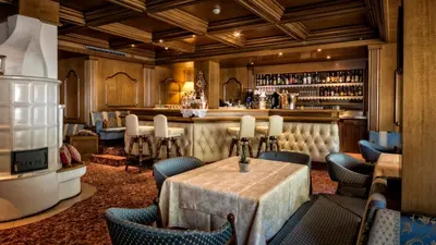a restaurant with a table and chairs and a bar at Hotel Armin in Selva di Val Gardena