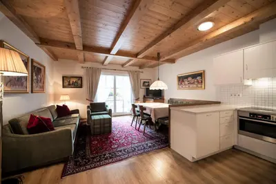 a kitchen and living room with a couch and a table at Residence Villa Stella in Ortisei